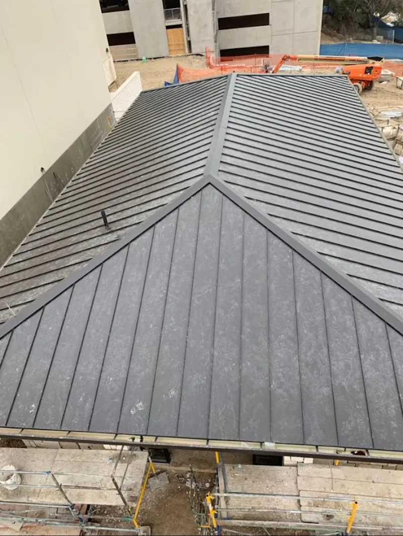 Commercial metal roof construction with crane equipment in Berwick